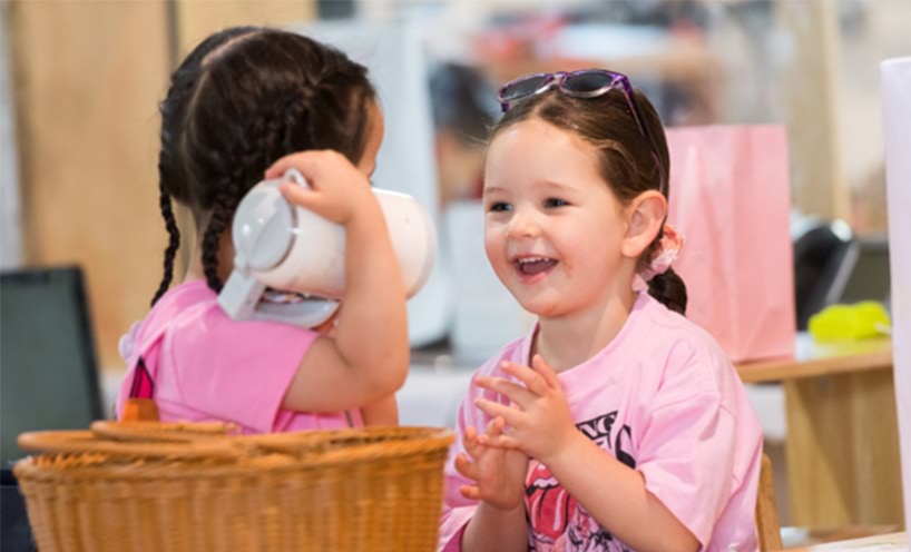 two young girls playing at childcare.